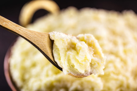 wooden spoon with Brazilian potato cream, called mashed potato, closeup of food from Brazil