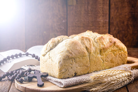 homemade bread made in the Easter and Eucharist period, called Christ bread, religious symbol, with...