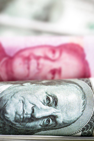 banknotes of 100 American dollars and 100 Chinese yuan Renminbi, trade tension between China and the...