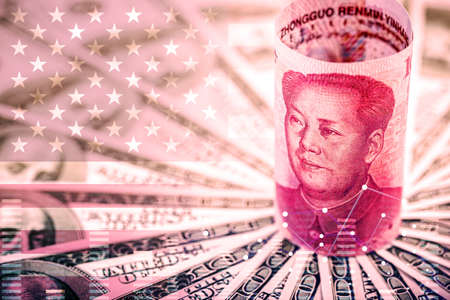 Chinese yuan banknote surrounded by colors of the American flag and dollar bills. Economic dispute between China and the United Statesの写真素材