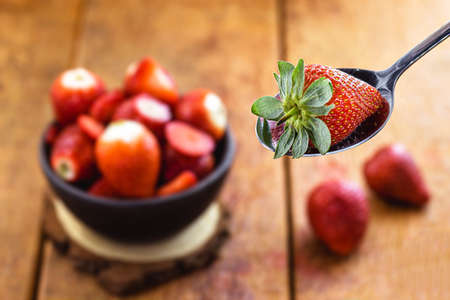 Brazilian strawberry in the spoon with punctual focus, fresh fruit, most consumed fruit in the world, sweet ingredientの写真素材