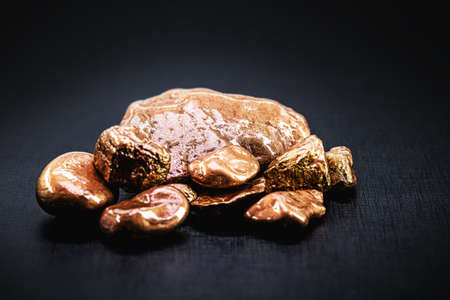 Sample of native copper isolated on black background, ore for industrial useの写真素材