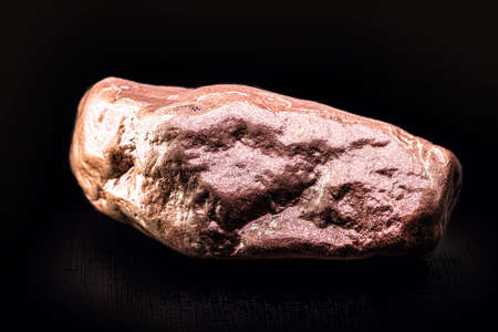 copper nugget isolated on black background, ore for industrial useの写真素材
