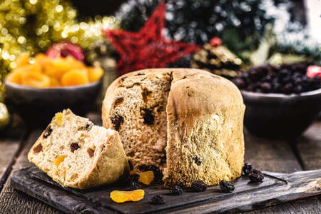 homemade fruit panettone, a typical Brazilian or Italian Christmas bread, with bokeh light in the backgroundの写真素材
