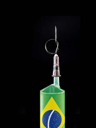 syringe or medical injection with flag of brazil on black background. Spot focus on the needle. Concept of crisis in Brazilian health in SUS - unique health systemの写真素材