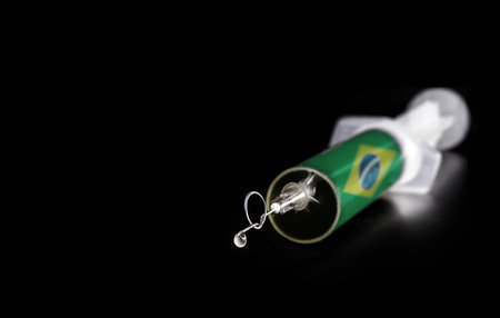 syringe or injection with brazil flag texture, the needle is bent, knotted, stuck. Concept of anti vaccine movement in Brazil, spot focusの写真素材