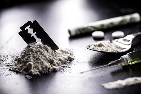 cocaine and heroin on dark wooden table, concept of addiction and chemical dependency, illegal drugsの写真素材