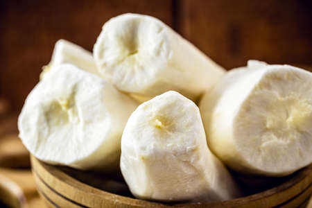 cassava, a root used in Brazilian cuisine, called macaxeira, cassava, castelinha, uaipi, sweet cassava, maniva, maniveira and poor bread. root inside wooden potsの写真素材