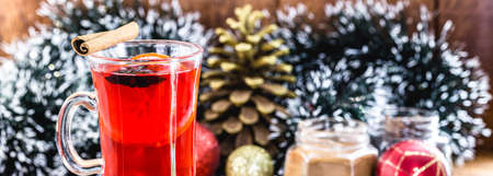 typical American or European Christmas drink. Mulled red wine with Christmas decoration in the backgroundの写真素材