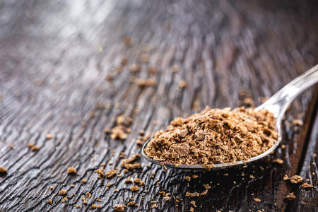 spoon with dark and bitter chocolate, on rustic wooden tableの写真素材