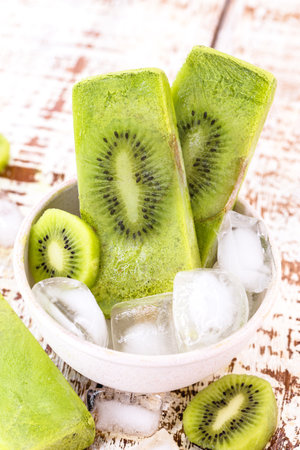 Kiwi ice cream with lemon, inside a recycled plastic bowl, natural fruit ice cream or ice popの写真素材