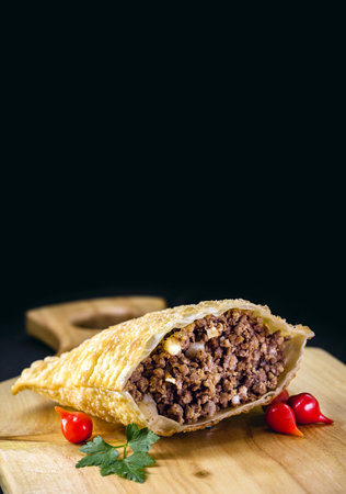 fried meat pastry cut in half, stuffed with minced meat and potatoes and hot sauce. Typical food in the city of SÃ£o Pauloの写真素材
