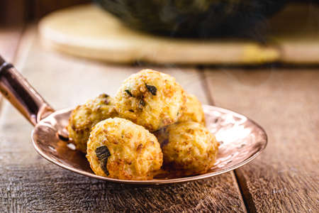 cod dumplings, fish meat dumpling in a slotted spoon, fried saltyの写真素材