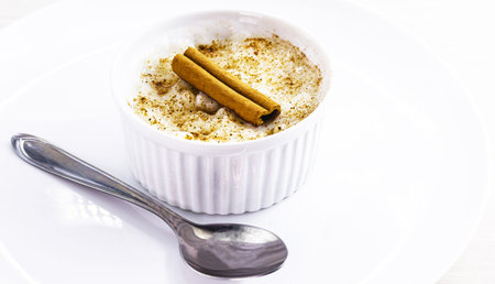 Creamy rice pudding dessert sprinkled and decorated with cinnamonの写真素材