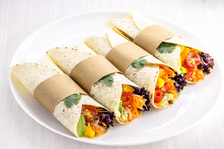 wrap or vegan burritos, made with dough without eggs, organic vegetables and avocado cream. Healthy quick meal.の写真素材