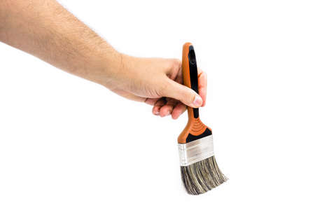 man hand painting white backdrop with professional brush, isolated white background and copy space.の写真素材