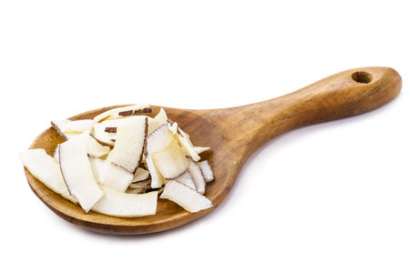 rustic wooden spoon with shredded coconut, coconut chips, isolated white background.の写真素材