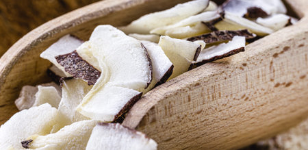 macro detail of culinary ingredient, grated coconut, piece of coconut or chip
