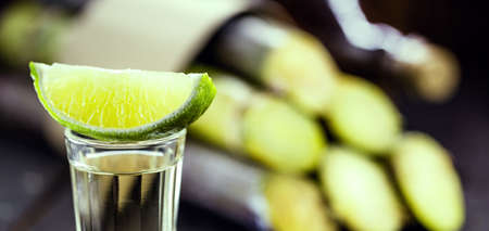 glass of alcoholic drink with lemon, distilled from sugar cane, called in Brazil pinga or cachaÃ§a