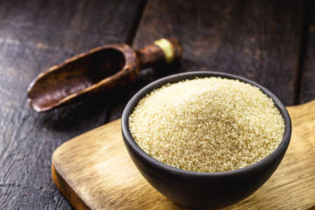 pure organic sugar in handmade clay pot with measuring spoon in the background, copyspaceの写真素材