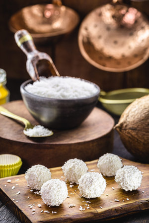 coconut balls, coconut candy with ingredients in the background, rustic and healthy cuisineの写真素材