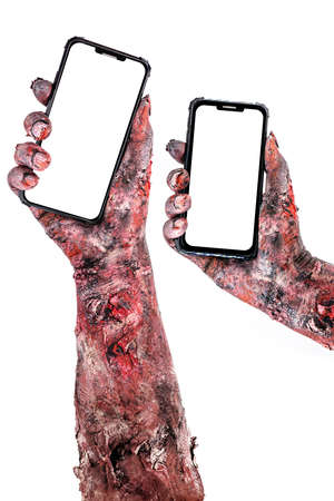 zombie or undead hands holding cell phone, copy space for textの写真素材