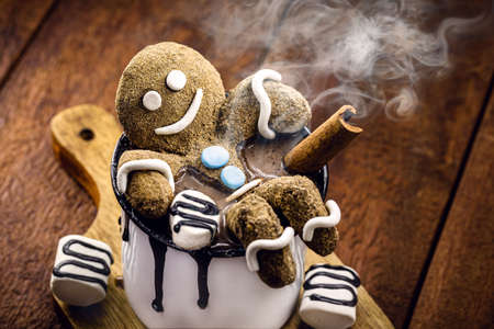 Hot chocolate with gingerbread man cookie and warm winter drink, fun food photoの写真素材