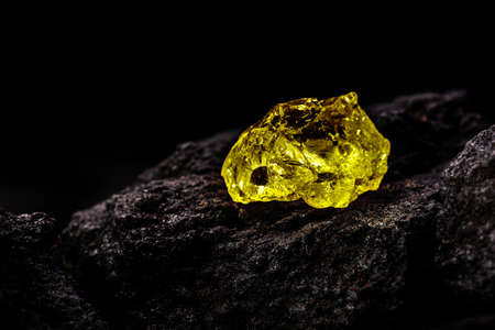 colored yellow quartz, esoteric stone, isolated black backgroundの写真素材