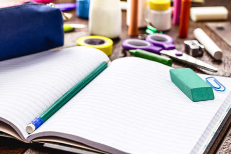 school notebook with copy space, school supplies around, back to school concept, space for promotional textの写真素材