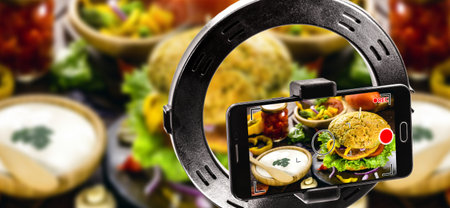 mobile device filming video of hamburger, snack image being recorded in high resolution for food...