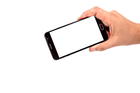 male hand holding cellphone black smartphone in horizontal position filming or photographing...