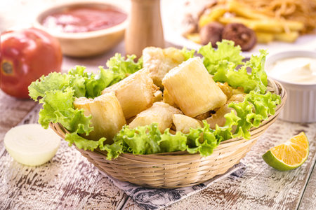 fried cassava with vegetables and sauces, a typical Brazilian snack served in restaurants and barsの写真素材