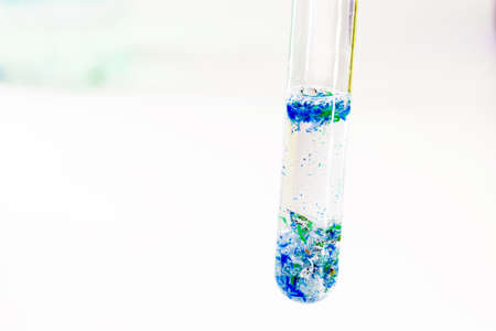 close-up of test tube with polluted water and traces of plastic and micro plastic taken from the ocean, polymer particles, environmental crisisの写真素材