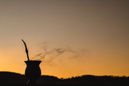 ChimarrÃ£o gourd at sunset, yerba mate infusion, served on cold winter days, gauchÃ¡ tradition,...