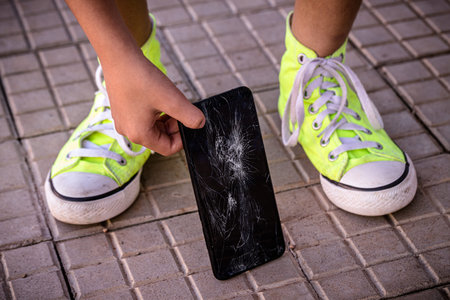 smartphone device with broken screen being picked up from floor by clumsy young man, cell phone film...