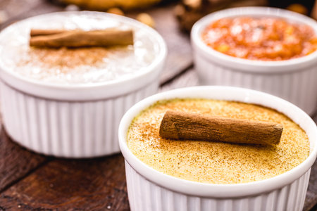 Typical Brazilian sweets from June festivals, curau, MugunzÃ¡ or hominy, sweet rice or Canjica,...