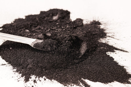 Powdered graphite with a measuring spoon or spatula, used for dry lubricating locks, padlocks, glass...