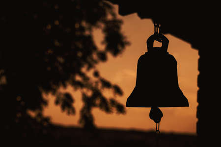 ancient bell silhouette in church , place of relaxation and worship, sunrise religion conceptの写真素材