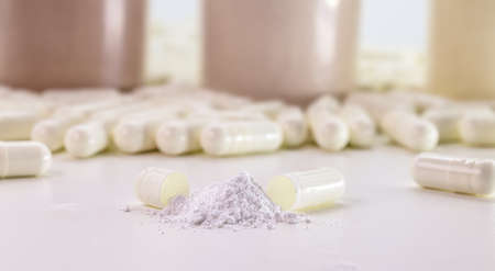 measuring spoon of creatine or whey powder, food supplement for physical activity or bodybuilding, white background or copy spaceの写真素材