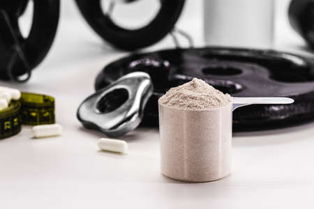 Measuring Spoon with Creatine or Whey, Food Supplement, Casein Cocktail, Muscle Mass Vitamin, Plated, Bodybuilding Conceptの写真素材