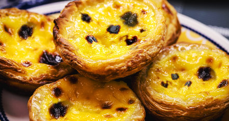 Portuguese Pastel de Nata, called Pastel de Belem, traditional Portuguese delicacy made with eggs,...