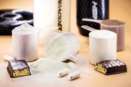 spoons with Creatine, whey and casein, amino acid pills, food supplements and protein bar for...