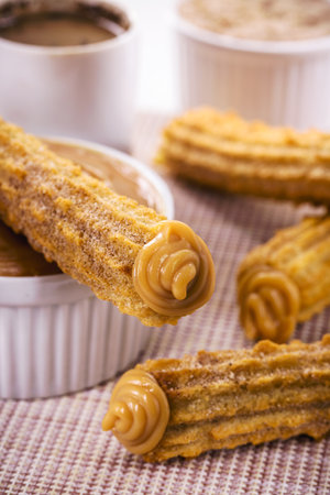 churros, fried sweet stuffed with dulce de leche, traditional from Brazilの写真素材