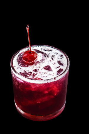 cherry-based refreshing alcoholic drink, red color, sweet taste, isolated black background, called cherry caipirinha or silk stockingの写真素材