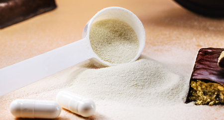 spoons with Creatine, whey and casein, amino acid pills, food supplements and protein bar for...