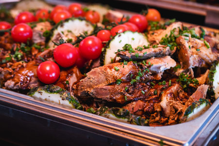 pork loin with vegetables, roast beef, served in a Brazilian restaurant or buffet, typical food for...