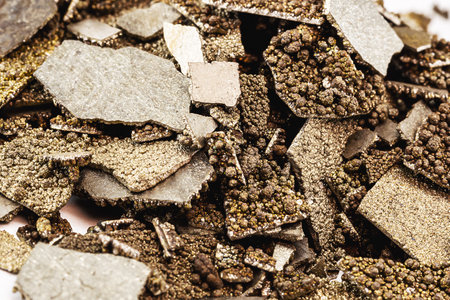 Manganese samples, flaked pure manganese metal used in industry, isolated white background.の写真素材