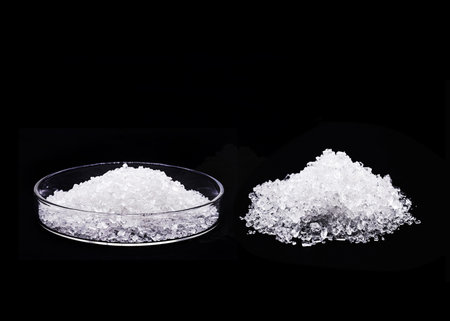 sodium chloride in petri dish, known as salt or table salt, important food preservative and popular...