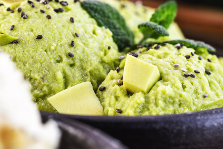 Homemade organic green avocado ice cream ready to eat, with mint leaf decorating.の写真素材