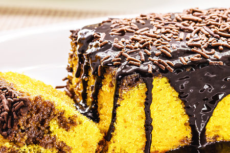 sliced ââââcarrot cake with chocolate sprinkles, creamy icing running down the cake, traditional sweet from Brazilの写真素材